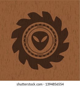 alien icon inside badge with wooden background