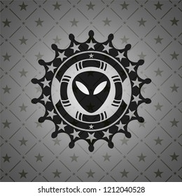 alien icon inside black emblem