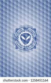 alien icon inside blue emblem or badge with abstract geometric pattern background.