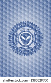 alien icon inside blue emblem with geometric pattern.