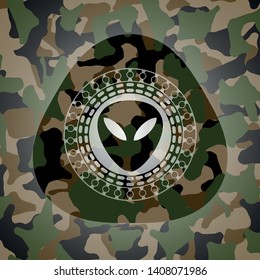 alien icon inside camouflaged emblem