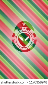 alien icon inside christmas style badge..