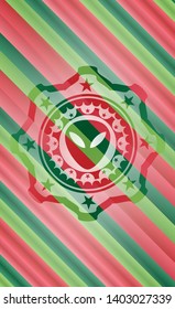 alien icon inside christmas style badge..