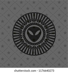 alien icon inside dark badge or emblem