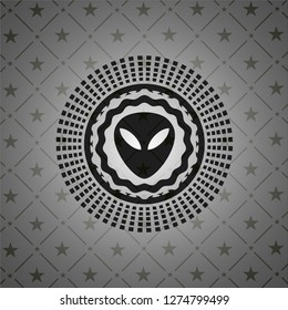 alien icon inside dark badge or emblem