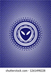 alien icon inside emblem with jean background