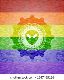 alien icon inside emblem on mosaic background with the colors of the LGBT flag