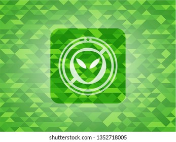 alien icon inside green emblem with triangle mosaic background