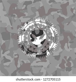 alien icon inside grey camouflage emblem