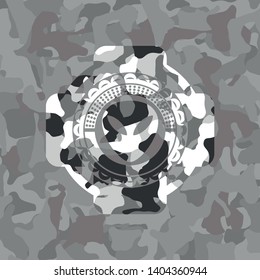 alien icon inside grey camouflage emblem