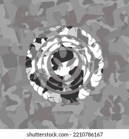 alien icon inside grey camouflaged emblem. 