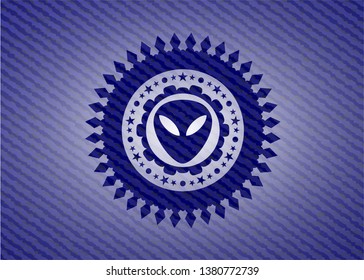 alien icon inside jean or denim emblem or badge background