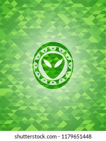 alien icon inside realistic green mosaic emblem