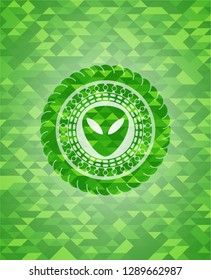 alien icon inside realistic green mosaic emblem
