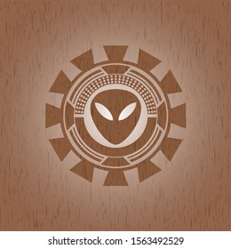 alien icon inside realistic wooden emblem