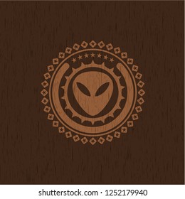 alien icon inside retro style wood emblem