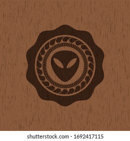 alien icon inside retro style wood emblem