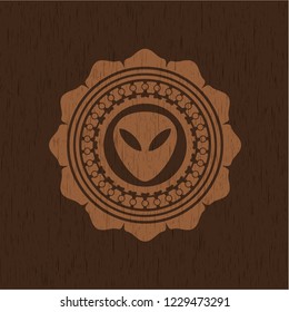 alien icon inside retro wood emblem