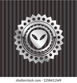 alien icon inside silvery badge