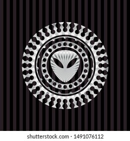alien icon inside silvery emblem or badge