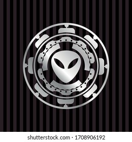 alien icon inside silvery emblem or badge. 