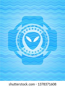 alien icon inside sky blue water wave badge background.