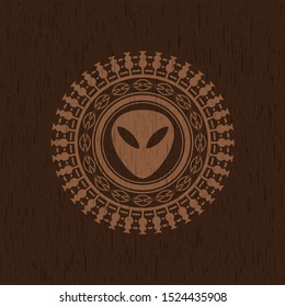 alien icon inside vintage wood emblem