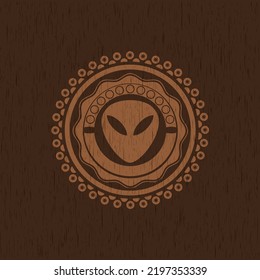 alien icon inside wooden emblem. Vintage. 
