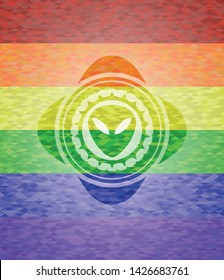 alien icon on mosaic background with the colors of the LGBT flag