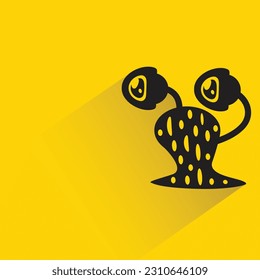 monstruo alienígena con sombra sobre fondo amarillo