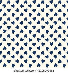 All over seamless vector repeat pattern with ditsy small navy blue hand drawn doodle hearts tossed as grid on cream. Simple cute Valentines day background