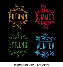 All seasons vignette Hand-sketched typographic element with leaves and snowflakes on black background.