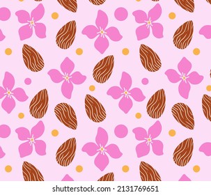 Almond nuts with flowers seamless pattern. Pink floral background with mandel and dots.