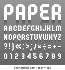 Alfabeto dobrado de papel. Alfabeto romano (A, B, C, D, E, F, G, H, I, J, K, L, M, N, O, P, Q, R, S, T, U, V, W, X, Y, Z) e algarismos árabes (0, 1, 2, 3, 4, 5, 6, 7, 8, 9).