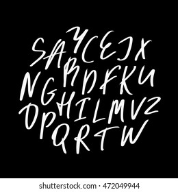 Alphabet letters.White handwritten font drawn with liquid ink and brush.Calligraphic script