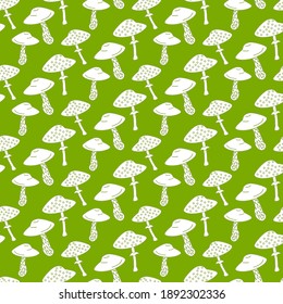 Amanita on a green background. Mushroom pattern vector illustration. For packaging, decoration, fabric, scrapbooking.