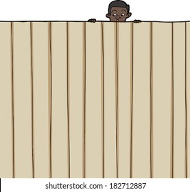 Amazed male child looking over wooden fence