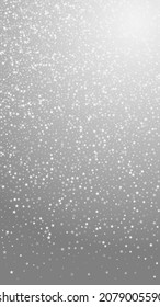 Amazing falling stars Christmas background. Subtle flying snow flakes and stars on grey background. Appealing winter silver snowflake overlay template. Quaint vertical illustration.