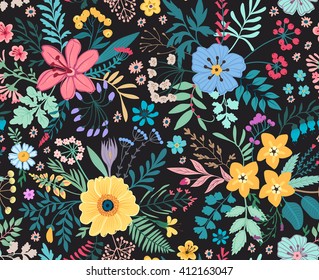 Amazing floral pattern with bright colorful flowers, plants, branches and berries on a black background. The elegant the template for fashion prints. Spring floral background.