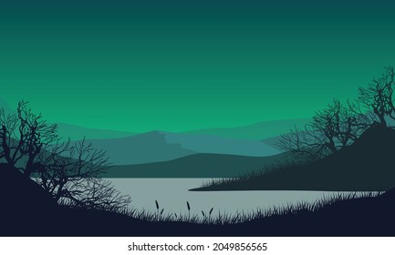 Amazing mountain view from the riverbank at night with the silhouettes of dry tree branches around it. Vector illustration of a city