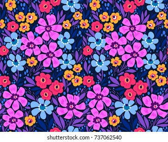 Amazing seamless floral pattern with bright colorful flowers and leaves on a dark blue background. The elegant the template for fashion prints. Modern floral background. Folk style.
