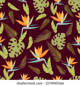 Amazing seamless flower pattern - Royal Strelitzia. The flower is made in orange, blue among tropical leaves on a dark  background. This pattern can be used for fabrics, for t-shirts, wallpapers.
