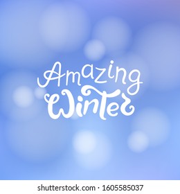 Amazing winter title. Brush lettering at blurred winter background with bokeh lights. Vector card design with handwritten calligraphy