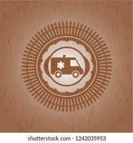 ambulance icon inside badge with wood background