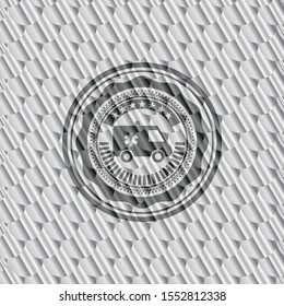 ambulance icon inside silver emblem or badge. Scales pattern. Vector Illustration. Detailed.