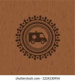 ambulance icon inside wooden emblem