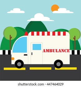 An ambulance is on the road with mountains in the background.