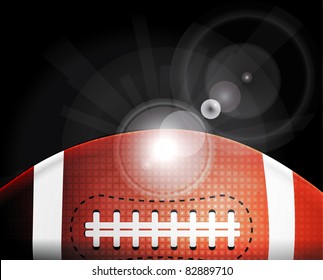 American football ball on black background with light