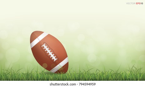 American football ball on green grass field with light blurred bokeh background. Vector illustration.