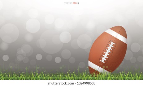 American football ball or rugby ball on green grass field with light blurred bokeh background. Vector illustration.